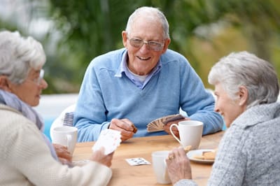 Seniors enjoying a card game outdoors