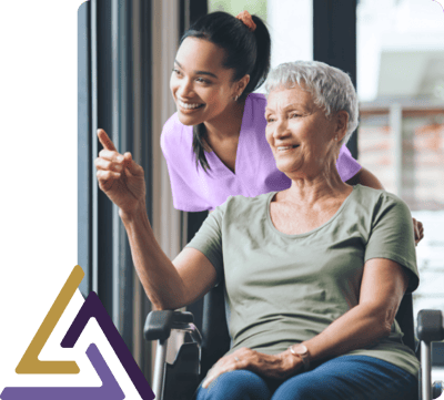 Caregiver assisting a resident in a cozy setting.