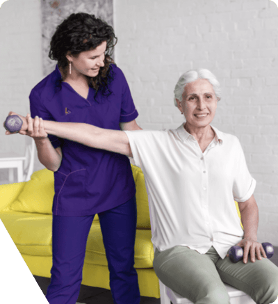 Staff assisting senior with weights in therapy session.