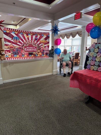 Residents participating in a carnival-themed event indoors.