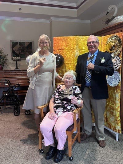 Residents and staff celebrating together indoors