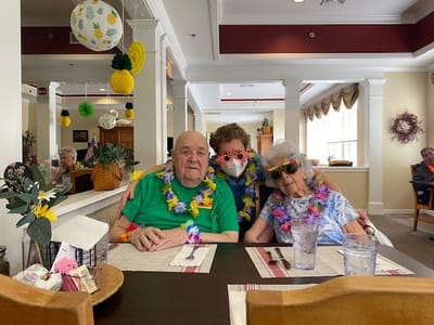 Residents enjoying a festive meal in the dining room.