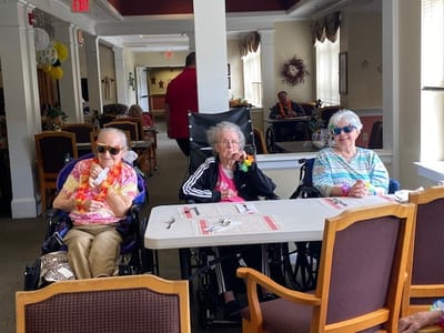 Three residents enjoying a cheerful gathering.
