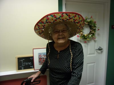 Resident wearing a large sombrero in a common area.