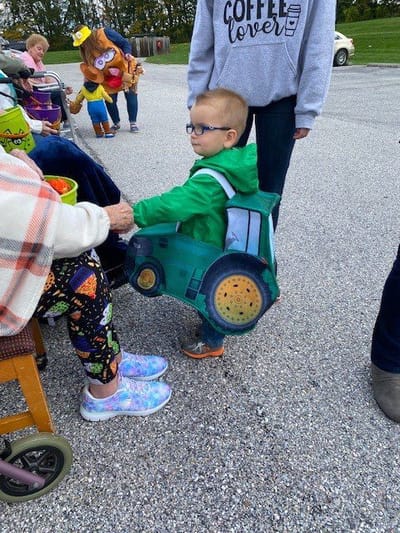 Child interacting with an older adult outdoors