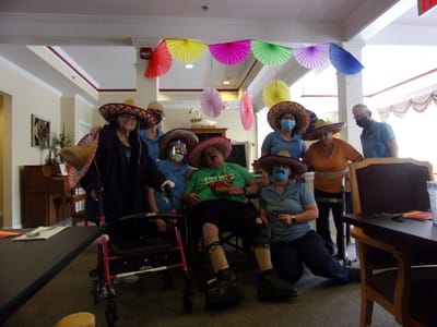 Residents and staff celebrating in festive attire