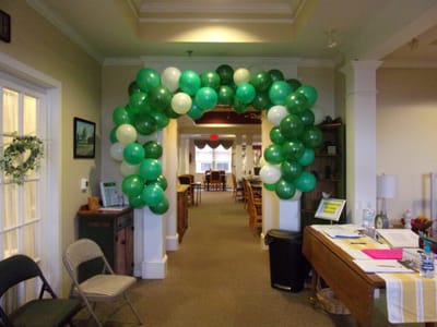 Balloon arch decoration in facility hallway.