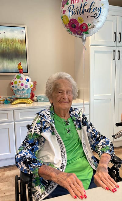 Resident celebrating a birthday with decorations.
