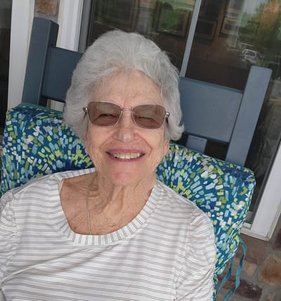 Senior resident smiling in a chair