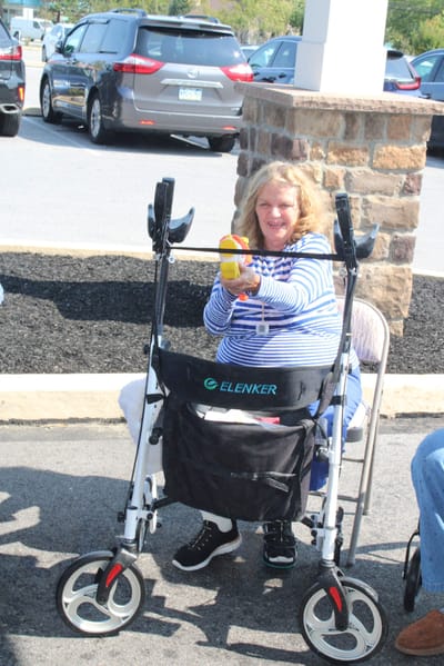 Resident enjoying time outdoors with a walker.