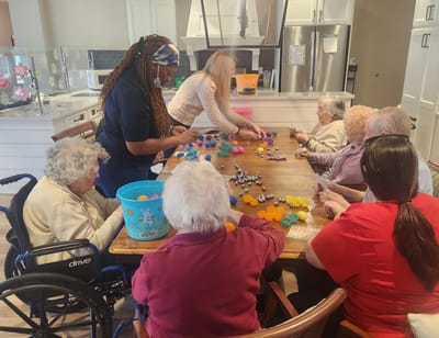 Residents engaged in a colorful activity at a table.