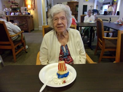 Resident enjoying a dessert in a common area.