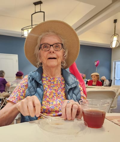 Senior resident enjoying a meal in the dining area.