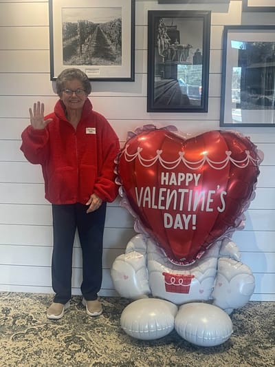 Resident celebrating Valentine's Day with balloon