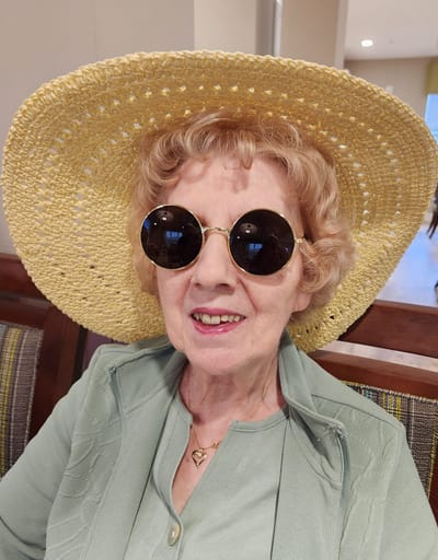Senior woman in sunglasses and a sun hat