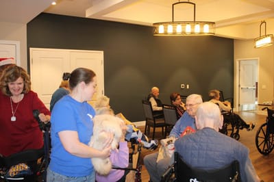Residents participating in an activity with staff assistance.
