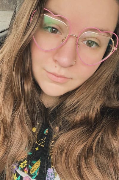 Young woman with heart-shaped glasses