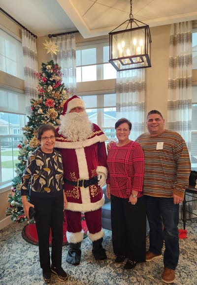 Residents and staff celebrating with Santa.
