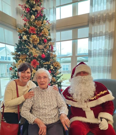 Resident with family and Santa in festive setting
