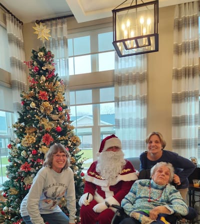 Residents celebrating with Santa in a festive interior