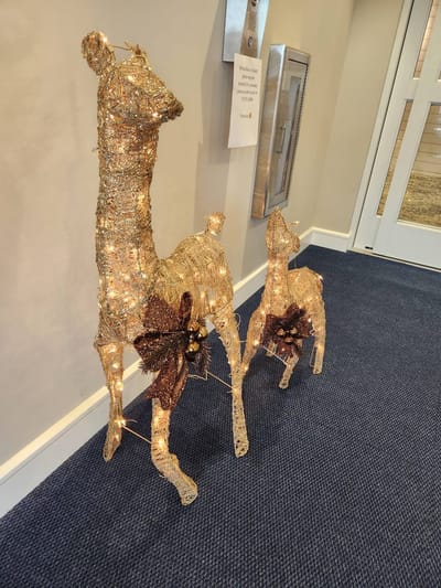 Decorative lighted reindeer figures in a hallway.