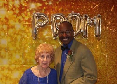 Residents enjoying a prom-themed event together.