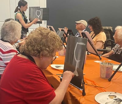 Residents engaged in a painting activity session.