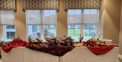 Buffet table with food and decorations in a dining area.