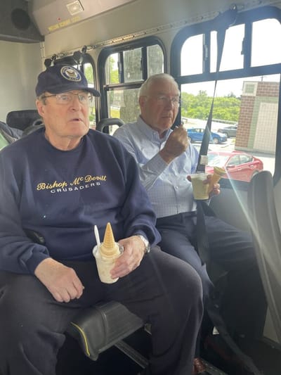 Two residents enjoying ice cream on a bus.