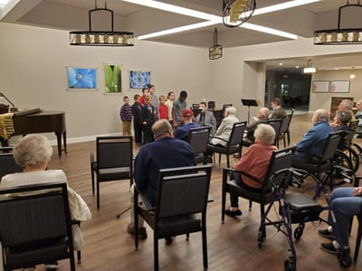 Residents and staff gathered in a common area for an event.