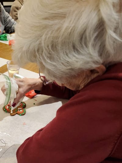 Resident decorating a gingerbread cookie