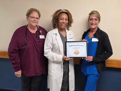 Staff members celebrating a certification achievement