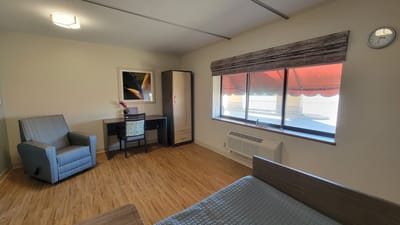 Spacious interior room with seating and desk.