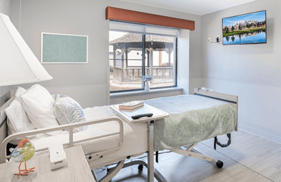Patient room with hospital bed and view outside