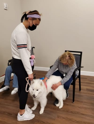 Resident interacting with a therapy dog.