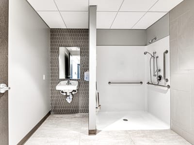 Accessible bathroom with grab bars and sink.
