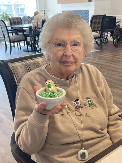 Senior resident enjoying a festive dessert treat.