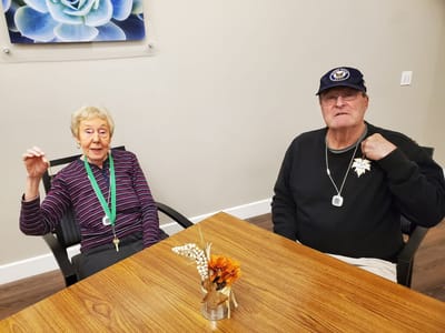 Two residents engaging in conversation in a common area.
