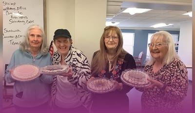 Four residents enjoying dessert together.
