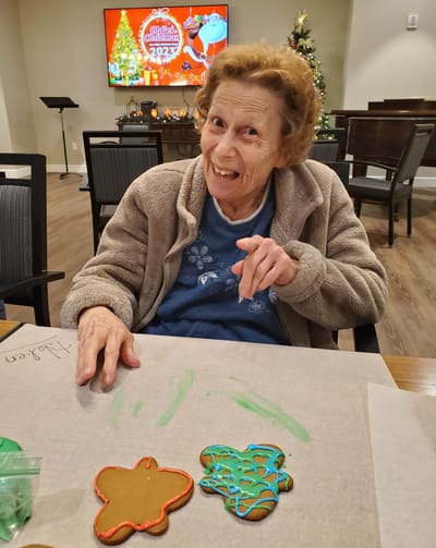 Resident decorating gingerbread cookies for Christmas.