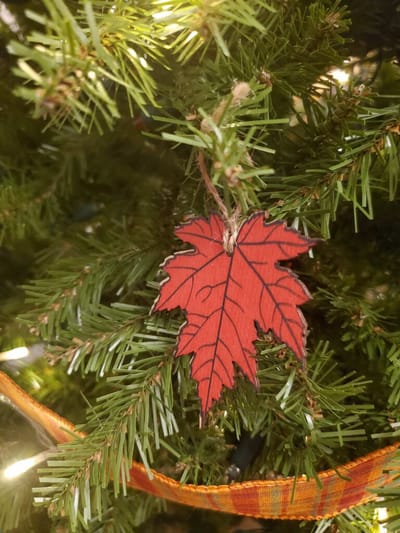 Red leaf ornament on a Christmas tree