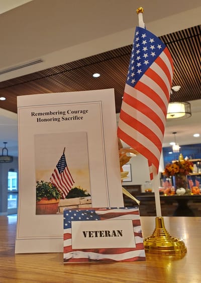 Veteran's display with American flag and sign.