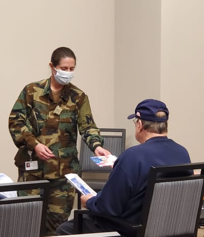 A staff member interacting with a resident indoors.