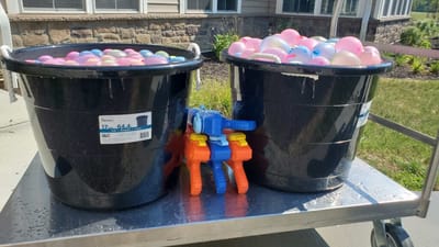 Buckets filled with colorful balls and toy guns
