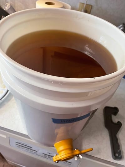 Container filled with dark liquid, unclear context