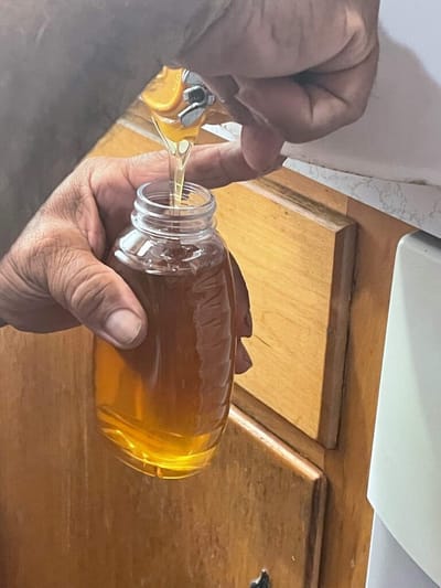 Hand pouring syrup from a bottle