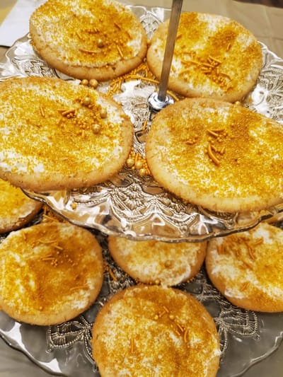 Platter of decorated cookies with gold sprinkles