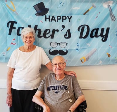 Residents celebrating Father's Day with a banner