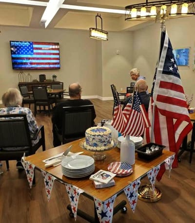 Residents celebrating with cake and decorations.