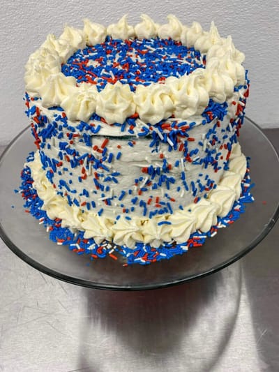 Decorative cake with red and blue sprinkles.